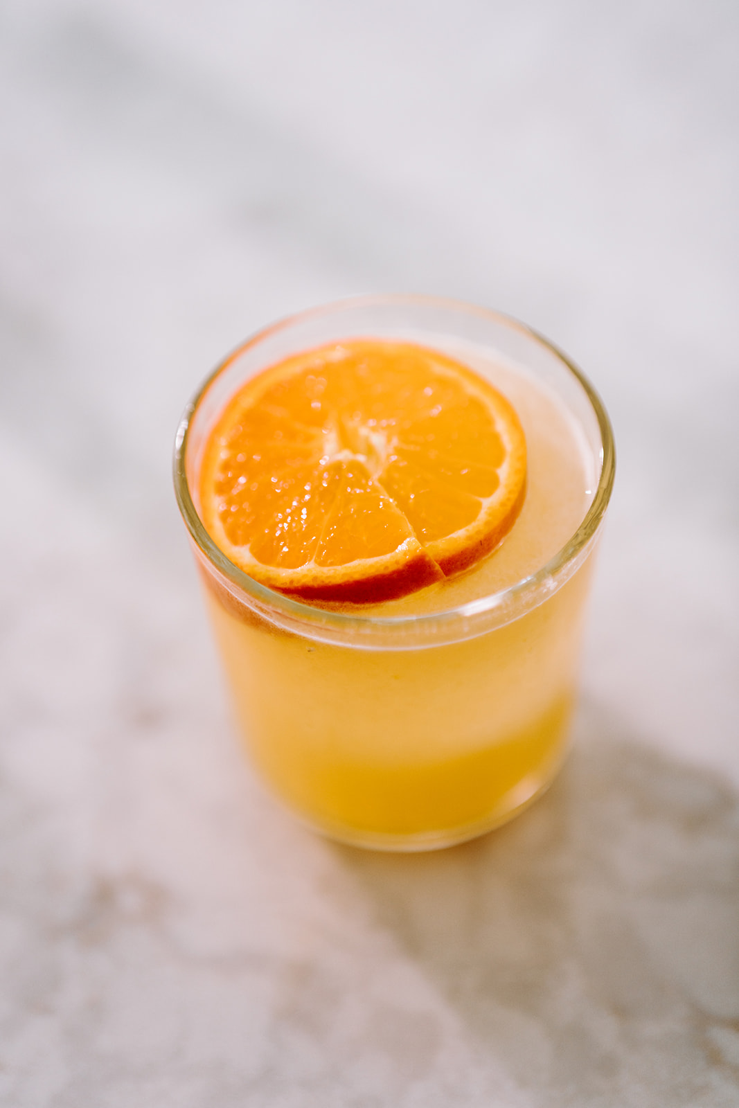 This simple and refreshing orange ginger margarita combines fresh squeezed orange juice, ginger simple syrup and tequila to make your new favorite margarita! Get the recipe on the blog kirstenturk.com