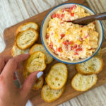 This simple pimento cheese recipe uses cream cheese, mayo, cheddar cheese and pimentos to make a delicious southern spread that's perfect for crostinis or pimento cheese sandwiches! It makes for a great appetizer or simple lunch. Get the full recipe on the blog at kirstenturk.com