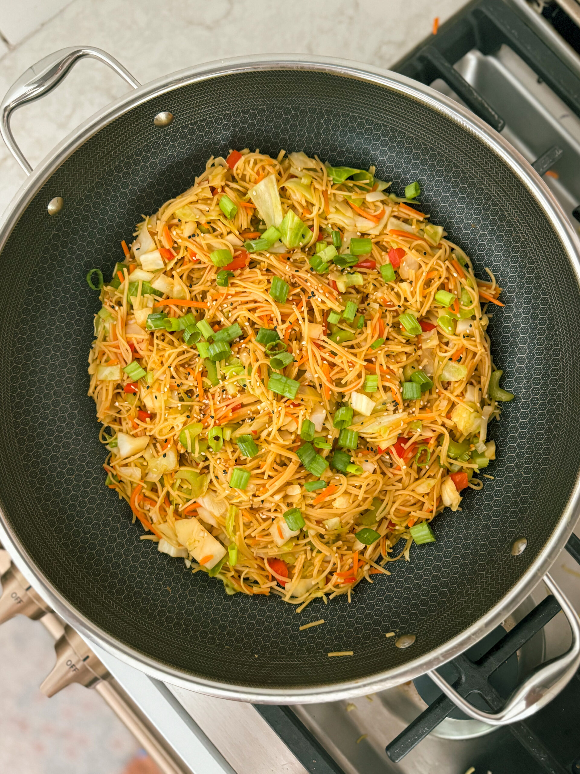 This Simple Veggie Chow Mein in a Wok makes an easy week night meal when you top it with your favorite protein like a fried egg or shrimp! This is an easy dinner recipe and perfect for making Chinese takeout at home! Get the full recipe on kirstenturk.com